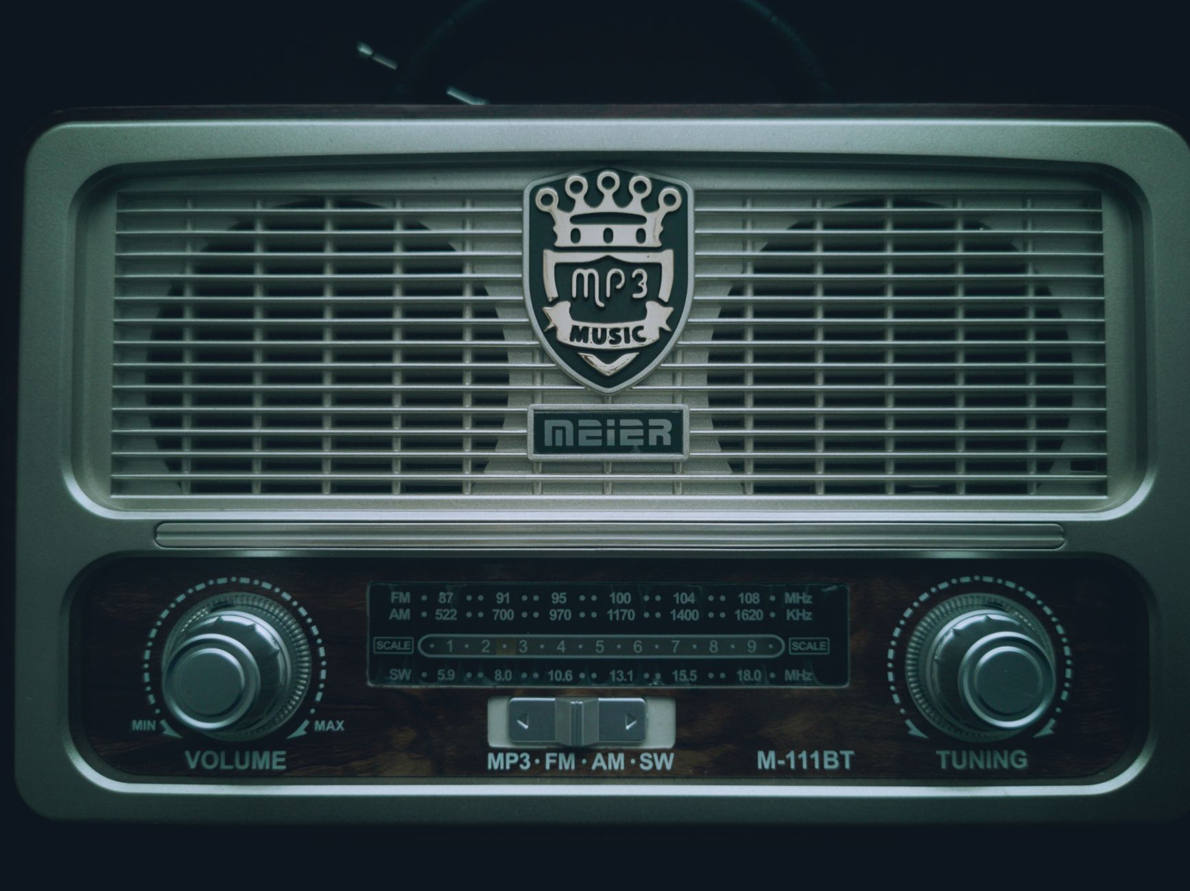 Close-up of a retro MP3 radio with tuning dials and vintage logo.