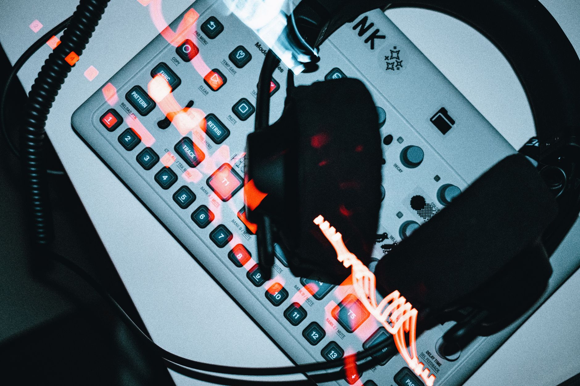 High-angle view of a groovebox with headphones, showcasing modern electronic music production.